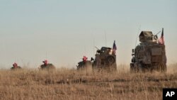 FILE - Turkish and U.S. troops conduct joint patrols around the Syrian town of Manbij, Nov. 1, 2018.