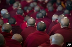 Exiled Tibetan Buddhist monks have ceremonial seeds on their shaven heads as they listen to a religious talk by their spiritual leader, the Dalai Lama, at the Tsuglakhang temple in Dharmsala, India, March 14, 2017.