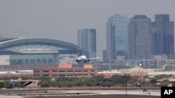 Heat waves appear across the tarmac at Sky Harbor International Airport, as downtown Phoenix stands in the background as an airplane lands, Tuesday, June 20, 2017 in Phoenix. An excessive heat warning was in place over the weekend (AP Photo/Matt York)