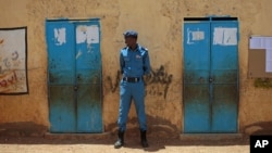 A member of the Sudanese security forces stands guard outside a polling station, on the second day of Sudan's presidential and legislative elections, in Izba, an impoverished neighborhood on the outskirts of Khartoum, Sudan, April 14, 2015.