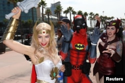 FILE - Attendees arrive dressed in costume for the opening day of Comic Con International in San Diego, California, July 20, 2017.