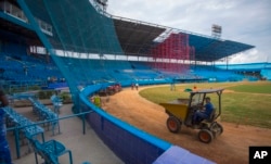 A crew attends to chores at the Latinoamericano Stadium baseball park in Havana, Cuba, March 4, 2016. President Barack Obama plans to attend the Tampa Bay Rays' exhibition game there on March 22 during his visit.