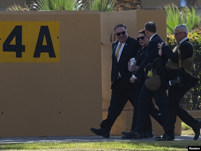 FILE - U.S. Secretary of State Mike Pompeo and his wife, Susan, walk at the U.S. Embassy compound in Baghdad, Jan. 9, 2019. The U.S. has ordered all non-essential personnel to leave the Iraq embassy.