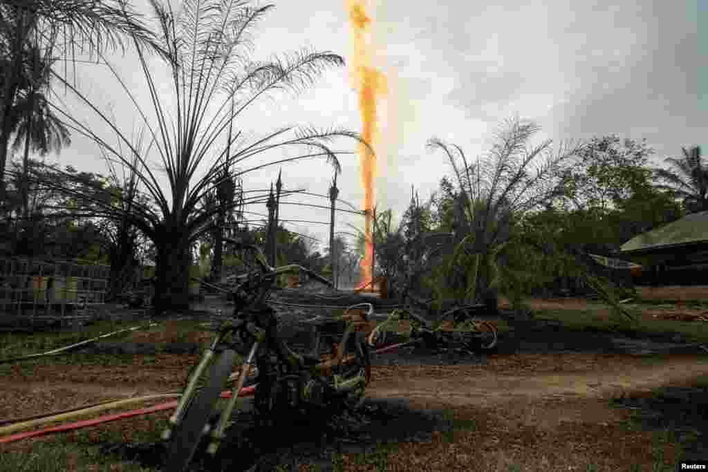 Damage caused by fire from a burning illegal oil well is seen in Ranto Peureulak, Aceh Province, Indonesia.