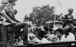 FILE - Members of the Youth Wing of the Indonesian Communist Party (Pemuda Rakjat) taken to prison in Jakarta, Oct. 30, 1965, after an abortive coup against President Sukarno's government earlier in the month.