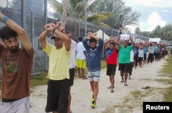 FILE - An undated image released Nov. 13, 2017, shows detainees staging a protest inside the compound at the Manus Island detention center in Papua New Guinea.