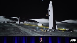 Billionaire entrepreneur and founder of SpaceX Elon Musk speaks below a computer-generated illustration of his new rocket at the 68th International Astronautical Congress 2017 in Adelaide, Australia, Sept. 29, 2017. 