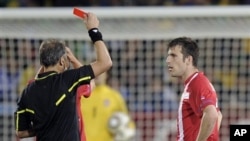 Argentine referee Hector Baldassi, left, gives a red card to Serbia's Aleksandar Lukovic during the World Cup group D soccer match between Serbia and Ghana at the Loftus Versfeld Stadium in Pretoria, South Africa, Sunday, June 13, 2010.