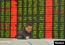 FILE - An investor looks at a computer screen showing stock information at a brokerage house in Fuyang, Anhui province, Jan. 28, 2016. Some say recent stock market turmoil will leave foreigners cautious about investing in China.