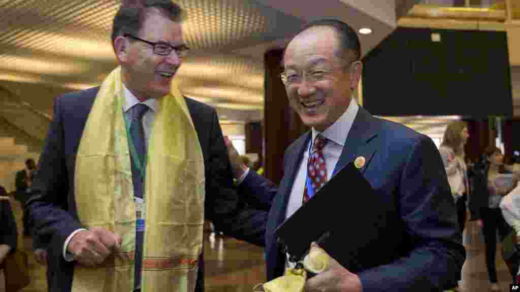 President of the World Bank Dr. Jim Yong Kim, right, reacts with Germany's Federal Minister of Economic Cooperation and Development, Dr. Gerd Muller, at The Third International Conference on Financing for Development, held in Addis Ababa, Ethiopia, Monday, July 13, 2015. According to the organizers, the conference which runs from July 13-16 is intended to gather world leaders to "launch a renewed and strengthened global partnership for financing people-centered sustainable development". (AP Photo/Mulugeta Ayene)