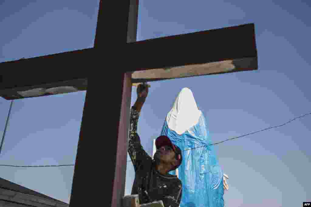모잠비크&nbsp;안타나나리보의 안도할로 성당에서 프란치스코 교황의 방문 준비가 한창인 가운데 인부가 성당 밖에 위치한 십자가를 페인트칠 하고 있다.
