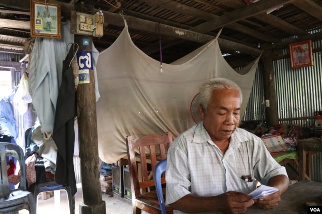 Chan Leap, 66, a district official for the opposition Cambodian National Rescue Party until it was dissolved in mid-November, sits at his house in Takeo province. He said he did not defect to the ruling Cambodian People’s Party, but urged others to do so.