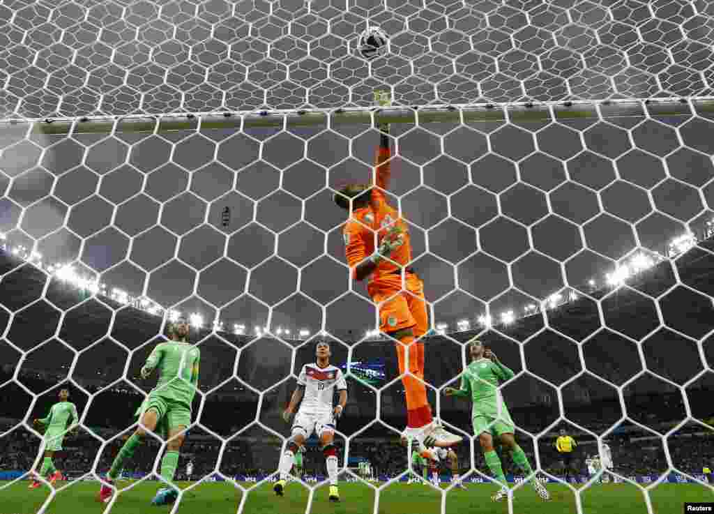 Algerian goalkeeper Rais Mbolhi taps the ball away during the game between Germany and Algeria, at the Beira Rio stadium, in Porto Alegre, June 30, 2014.