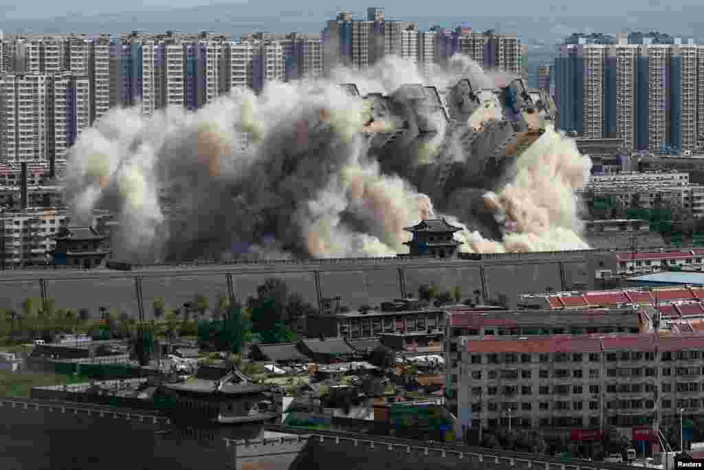 A building crumbles during a controlled demolition in the city of Datong, Shanxi province, China.