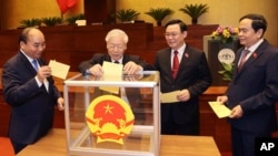 Vietnamese leaders cast ballot to elect new Prime Minister, from left, President Nguyen Xuan Phuc, Communist General Secretary Nguyen Phu Trong, Chairman of National Assembly Vuong Dinh Hue and newly elected Prime Minister Pham Minh Chinh in Hanoi, Vietnam April 5, 2021. 