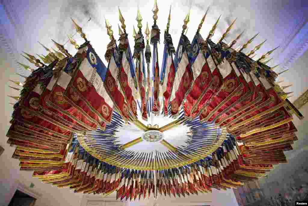 The tri-color - blue, white and red&nbsp; - flags and banners from 182 disbanded French military regiments are arranged in a circle as they hang from the ceiling in the Emblems Room at the Chateau de Vincennes, near Paris.
