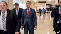 Former Trump campaign manager Cory Lewandowski, center, and his lawyer Peter Chavkin, second from left, arrive to meet behind closed doors with the House Intelligence Committee, at the Capitol in Washington, March 8, 2018.
