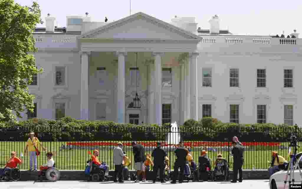 Police issue citations for blocking the front of the White House to wheelchair-bound demonstrators who had chained themselves to the White House fence on Pennsylvania Avenue in Washington in this April 27, 2009 file photo.
