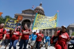 FILE - Students and faculty attend a rally on the steps of the Texas Capitol in support of charter schools, in Austin, April 26, 2017.