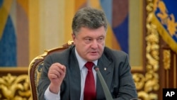 FILE - Then-Ukrainian President Petro Poroshenko speaks at the Security Council meeting in Kyiv, July 17, 2014. 