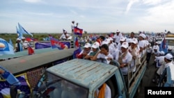 Supporters of the Cambodian People's Party (CPP) stand on a truck as they are surrounded by supporters of the Cambodia National Rescue Party (CNRP) during a local election campaign in Phnom Penh, Cambodia May 20, 2017.