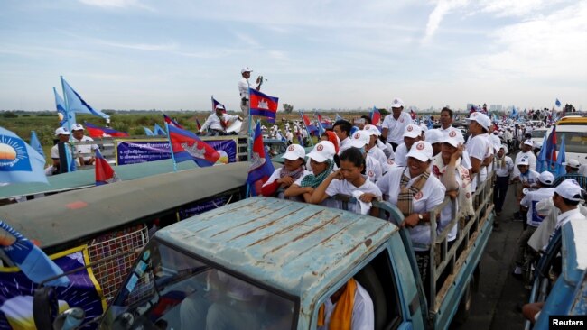 Supporters of the Cambodian People's Party (CPP) stand on a truck as they are surrounded by supporters of the Cambodia National Rescue Party (CNRP) during a local election campaign in Phnom Penh, Cambodia May 20, 2017.