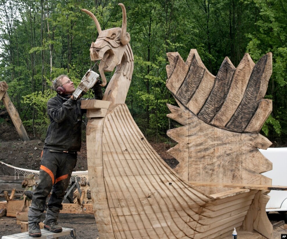 Oliver Vogt of Norway carves a wooden figure during the chain saw carving World Championship in Dorfchemnitz, eastern Germany.