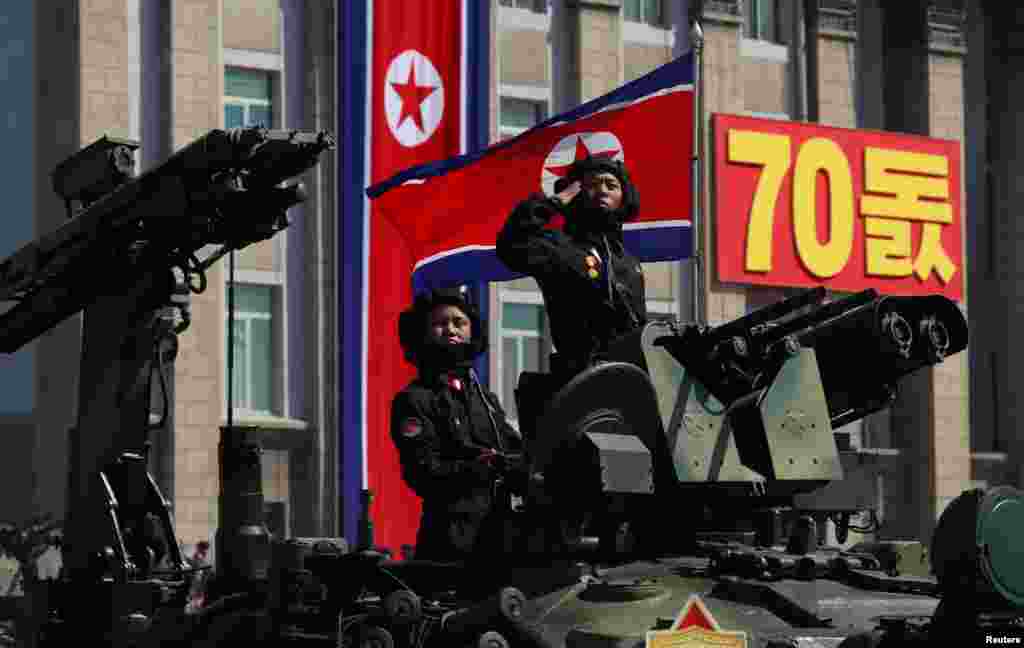 A soldier salutes as he rides a tank during a military parade marking the 70th anniversary of North Korea's foundation in Pyongyang, North Korea, Sept. 9, 2018. 