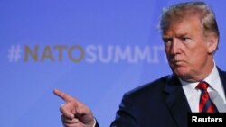 U.S. President Donald Trump gestures at his press conference after the NATO Summit in Brussels, Belgium, July 12, 2018. 