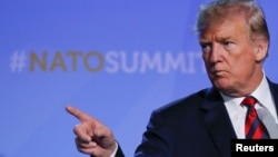 U.S. President Donald Trump gestures at his press conference after the NATO Summit in Brussels, Belgium, July 12, 2018. 