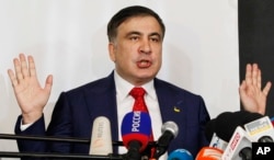 FILE - Mikheil Saakashvili, former Georgian president-turned-Ukrainian opposition leader, speaks to reporters in Warsaw, Poland, Feb. 13, 2018.