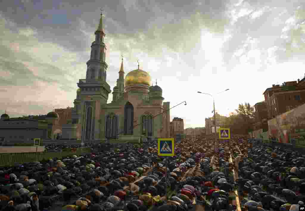 Muslims pray outside the newly restored Moscow Cathedral Mosque during celebrations of Eid al-Adha, in Moscow, Russia.