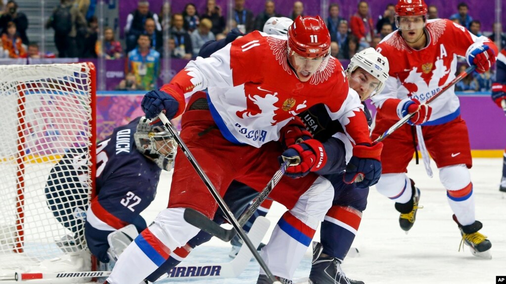 Russia forward Yevgeni Malkin seals off the puck from USA defenseman Ryan McDonagh in the first period of a men's ice hockey game at the 2014 Winter Olympics, Saturday, Feb. 15, 2014, in Sochi, Russia. (AP Photo/Mark Humphrey, File)