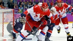 Russia forward Yevgeni Malkin seals off the puck from USA defenseman Ryan McDonagh in the first period of a men's ice hockey game at the 2014 Winter Olympics, Saturday, Feb. 15, 2014, in Sochi, Russia. (AP Photo/Mark Humphrey, File)
