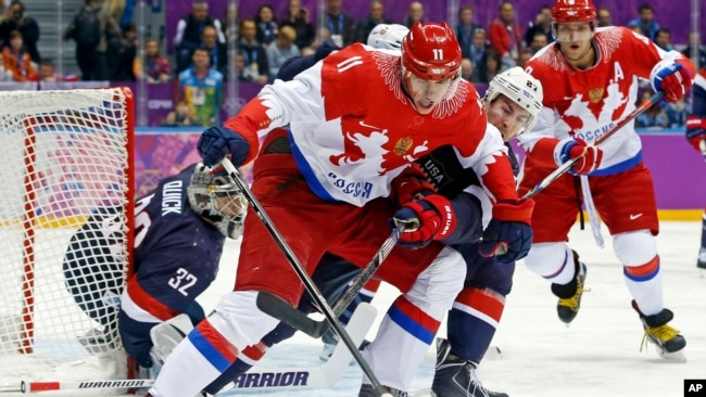 Russia forward Yevgeni Malkin seals off the puck from USA defenseman Ryan McDonagh in the first period of a men's ice hockey game at the 2014 Winter Olympics, Saturday, Feb. 15, 2014, in Sochi, Russia. (AP Photo/Mark Humphrey, File)