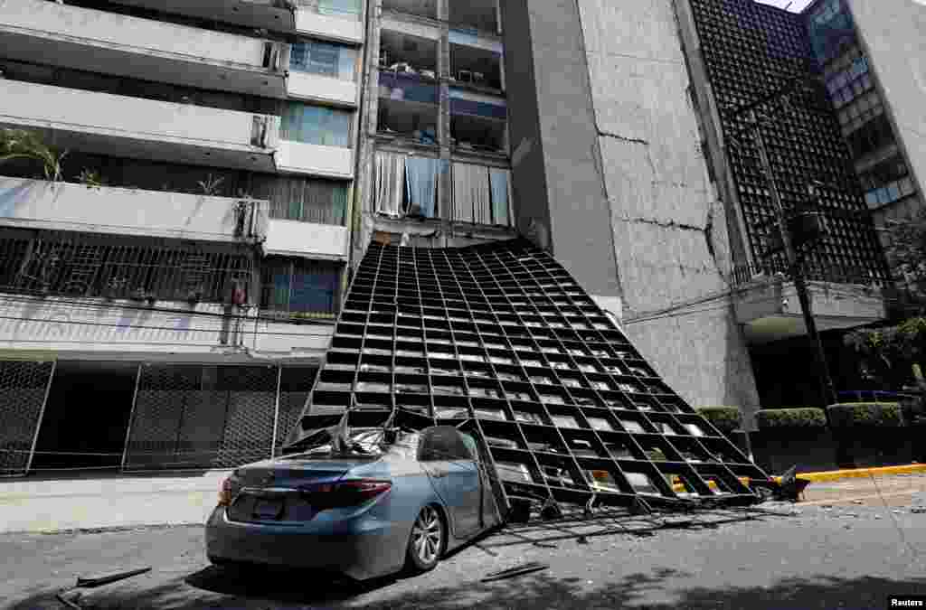 A damaged car is seen outside a building after an earthquake in Mexico City, Sept. 19, 2017.