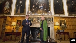 British Prime Minister David Cameron, left, speaks during a press conference with President Hamid Karzai of Afghanistan at the Prime Minister's country residence of Chequers, at Ellesborough west of London, January 28, 2012.