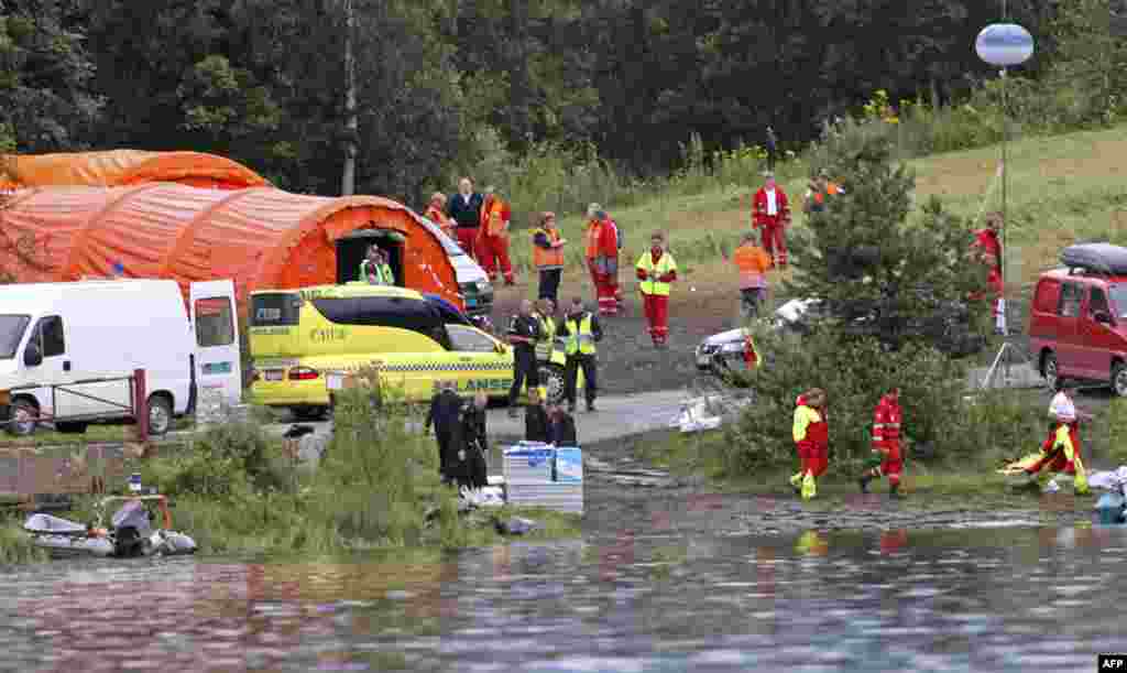 Rescue workers set up a camp across a lake, opposite the small, wooded island of Utoeya July 23, 2011. A suspected right-wing Christian gunman in police uniform killed at least 84 people in a ferocious attack on a youth summer camp of Norway's ruling Labo
