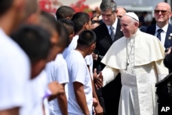 Before departing Pope Francis shakes hands with inmates after a penitential liturgy at the Las Garzas de Pacora detention center for minors, in Panama, Jan. 25, 2019.