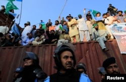 Police stand guard after protesters broke through police lines during a protest against Myanmar's persecution of Rohingya Muslims in Islamabad, Pakistan, Sept. 8, 2017.