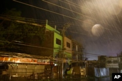 Strong winds and rain batter buildings and business establishments as Typhoon Mangkhut hits Tuguegarao city, Cagayan province, northeastern Philippines, Sept. 15, 2018. Typhoon Mangkhut slammed into the country's northeastern coast early Saturday.