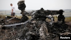 Debris is pictured at the site of Thursday's Malaysia Airlines Boeing 777 plane crash, near the village of Grabovo in the Donetsk region July 18, 2014. World leaders demanded an international investigation into the shooting down of Malaysia Airlines Fligh