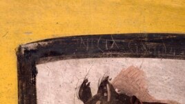 This undated image provided by Pompeii Archaeological Park's press office shows a painting of a dog on a leash at a recently uncovered thermopolium, or fast-food eatery, at Pompeii. @Luigi Spina (Courtesy)
