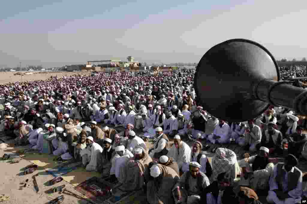 Afghans listen to a preacher while offering the Eid al-Adha prayers at a mosque on the outskirts of Jalalabad east of Kabul, Afghanistan, October 26, 2012. 