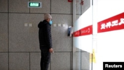 A man has his face scanned by a facial recognition device that identifies people when they wear masks to gain entrance to the office of Chinese electronics manufacturer Hanwang Technology in Beijing. Picture taken March 6, 2020. (Reuters/Thomas Peter)
