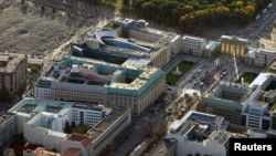  FILE - An aerial view over the British embassy (c), Hotel Adlon (lower l), the Academy of Arts and the U.S. Embassy (top), between the Holocaust memorial (top L) and the public square Pariser Platz, with the Brandenburg Gate (top r) toward the Tiergarten