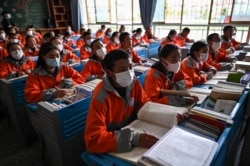 FILE - This photograph taken during a government-organized media tour shows students in a classroom at the Lhasa Nagqu Second Senior High School in the regional capital Lhasa, in China's Tibet Autonomous Region, June 1, 2021.