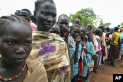 FILE - Female child refugees who escaped violence queue up inside Yida refugee camp, South Sudan, June 30, 2012.