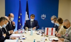 Presiden Perancis Emmanuel Macron (tengah) memimpin pertemuan pertemuan keamanan nasional untuk membahas spyware Pegasus di ruang Jupiter di The Elysee Presidential Palace, Paris, 22 Juli 2021. (AFP)