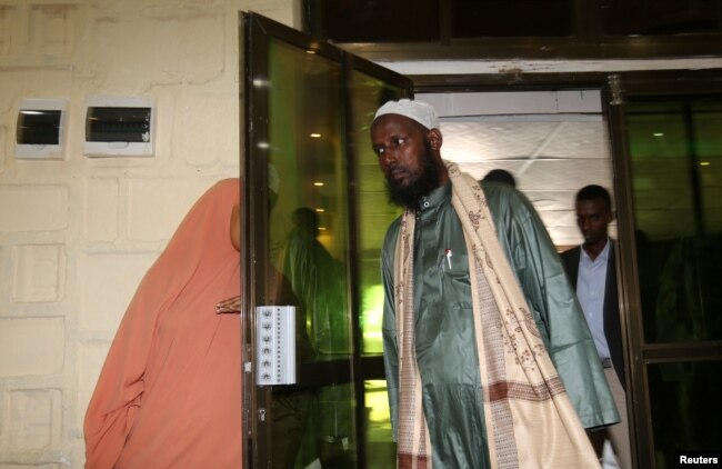 FILE - A former top leader of al-Shabaab, Mukhtar Robow, arrives for a news conference in Mogadishu, Aug. 15, 2017. Robow has condemned Saturdays's bombing attack in Mogadishu which has claimed at least 276 lives.